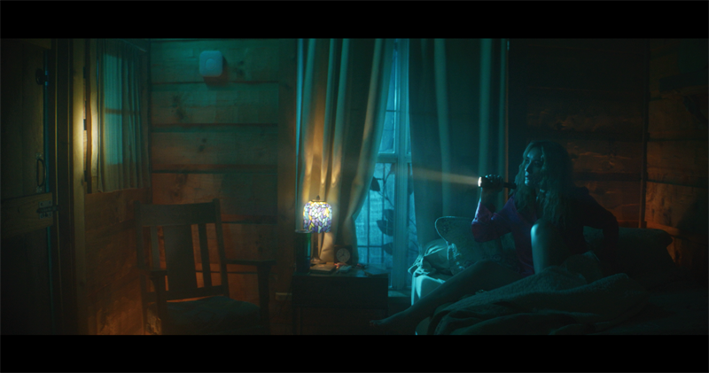 A suspenseful film scene using slow pacing and dramatic lighting
