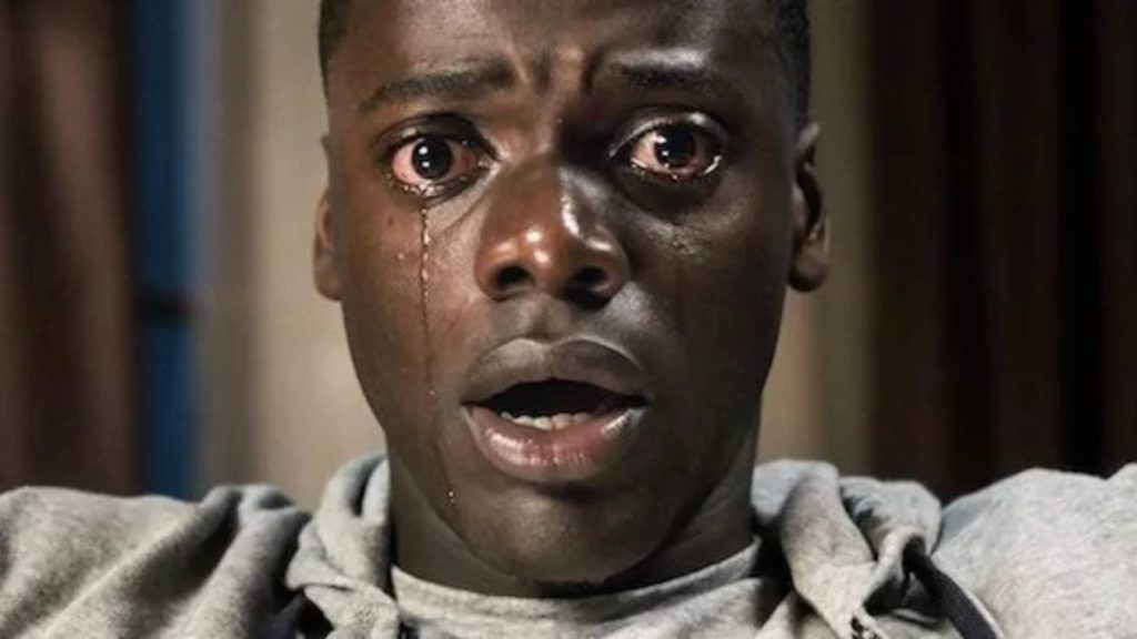 Close-up of a movie character expressing inner emotional conflict
